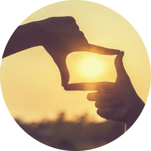 Hands framing the sun, symbolizing a big-picture perspective in special education advocacy and planning